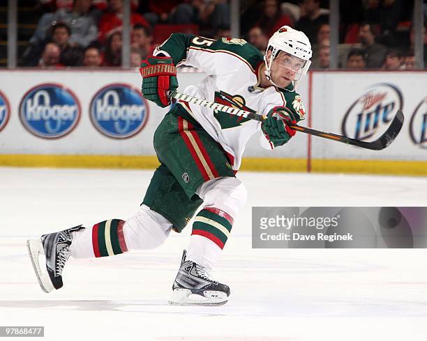 Nick Schultz of the Minnesota Wild takes a slap shot during an NHL game against the Detroit Red Wings at Joe Louis Arena on March 11, 2010 in...