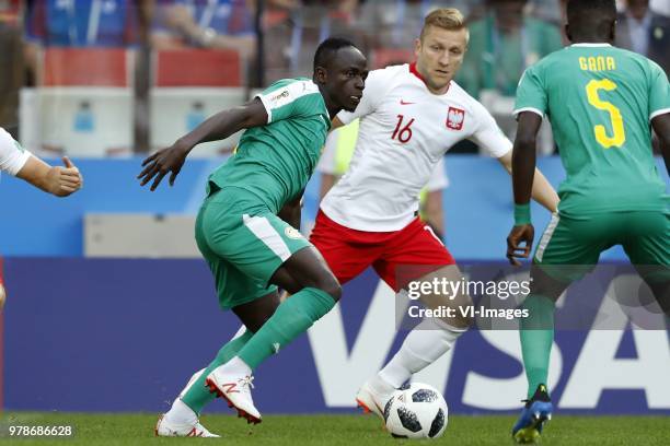 Lukasz Piszczek of Poland, Sadio Mane of Senegal, Jakub Blaszczykowski of Poland during the 2018 FIFA World Cup Russia group H match between Poland...