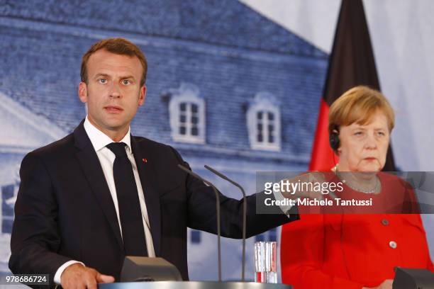 German Chancellor Angela Merkel and French President Emmanuel Macron address the media during a joint press conference at Schloss Meseberg...