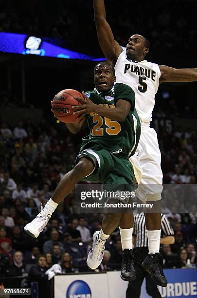 Ronald Moore of the Siena Saints shoots the ball against Keaton Grant of the Purdue Boilermakers during the first round of the 2010 NCAA men's...