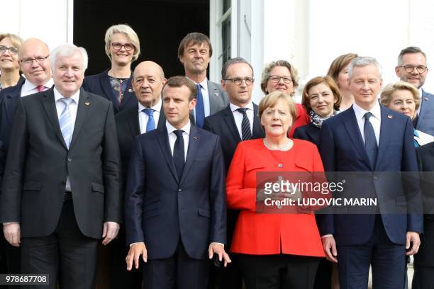 Chancellor Angela Merkel and French President Emmanuel Macron pose with their Ministers, including German Interior Minister Horst Seehofer , French...