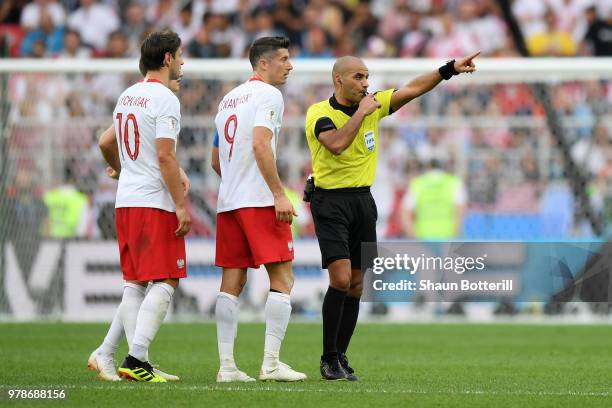 Referee Nawaf Shukralla talks to Robert Lewandowski, Piotr Zielinski and Grzegorz Krychowiak of Poland during the 2018 FIFA World Cup Russia group H...