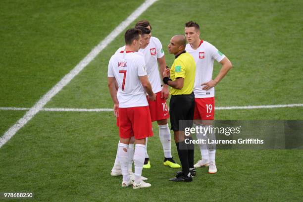 Referee Nawaf Shukralla talks to Robert Lewandowski of Poland during the 2018 FIFA World Cup Russia group H match between Poland and Senegal at...