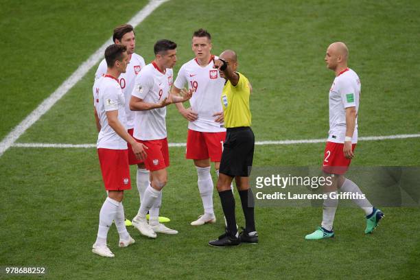 Referee Nawaf Shukralla talks to Robert Lewandowski of Poland during the 2018 FIFA World Cup Russia group H match between Poland and Senegal at...