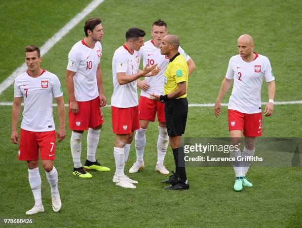 Referee Nawaf Shukralla talks to Robert Lewandowski of Poland during the 2018 FIFA World Cup Russia group H match between Poland and Senegal at...