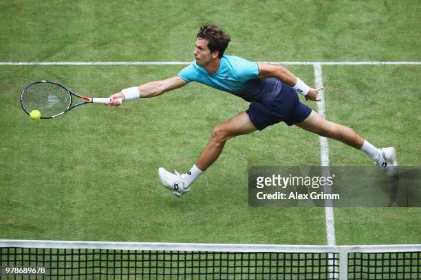 Aljaz Bedene of Slovenia plays a volley to Roger Federer of Switzerland during their first round match on day 2 of the Gerry Weber Open at Gerry...
