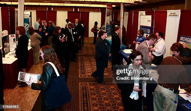 Job seekers speak with recruiters at Eastern Michigan University's collegiate job fair in Livonia, Michigan, U.S., on Friday, March 19, 2010. The...