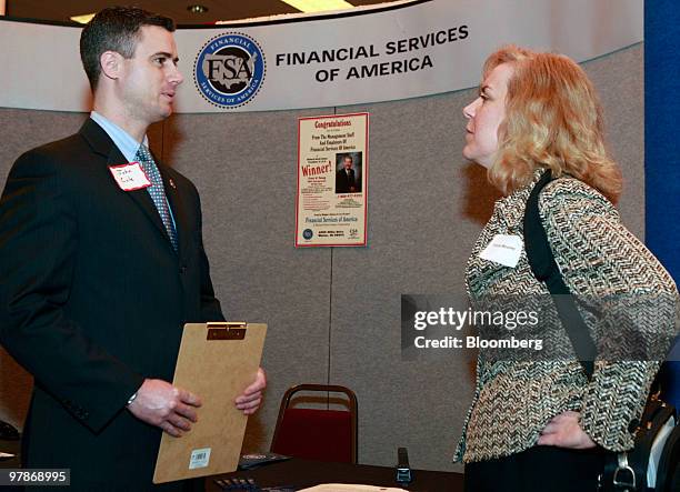 John Cole of Financial Services of America, left, talks with job seeker Tricia Mooney at Eastern Michigan University's collegiate job fair in...