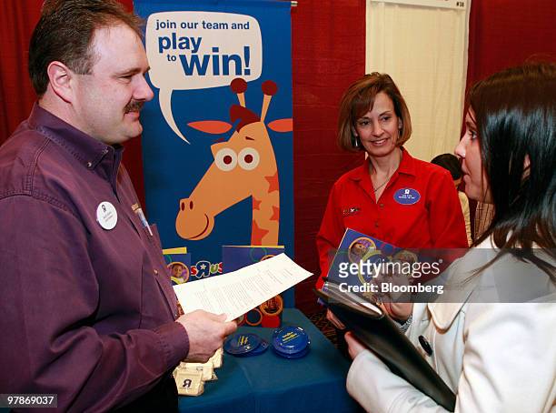 Job seeker Anna Roman, right, speaks with district manager Mark Adams, left, and Coleen Raymond regional human resources manager of Toys R Us Inc.,...