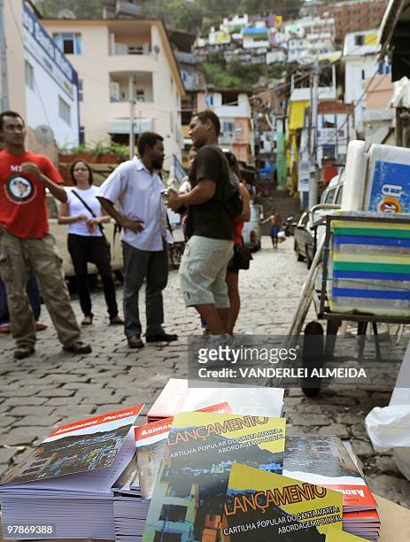 Unidentified residents of Dona Martha shantytown in Rio de Janeiro, Brazil, discuss about the new instructive booklet "Abordagem Policial" explaining...