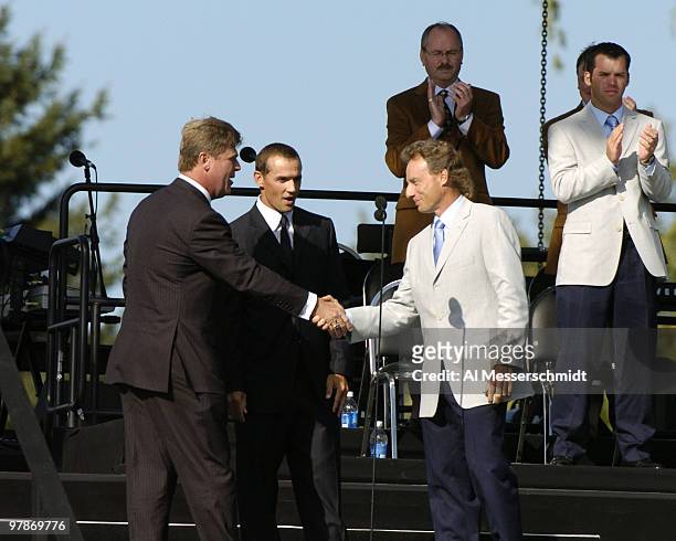 With Detroit Redwings superstar Steve Yzerman as the referee, Ryder Cup captains Hal Sutton and Bernhard Langer share a moment on stage during...