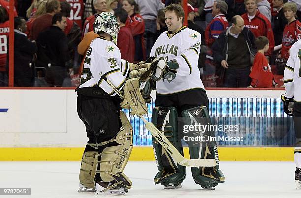 Marty Turco of the Dallas Stars celebrates against the Washington Capitals with teammate Kari Lehtonen on March 8, 2010 at the Verizon Center in...