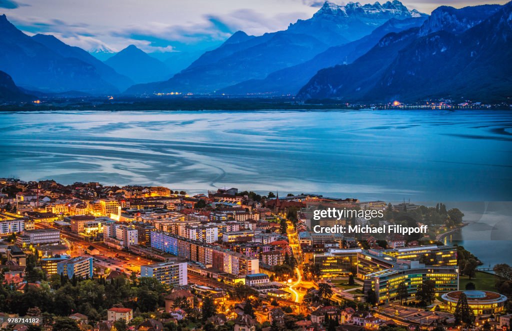 Illuminated lakeside city during dusk, Vevey, Switzerland