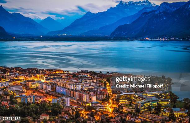 illuminated lakeside city during dusk, vevey, switzerland - lago de genebra imagens e fotografias de stock