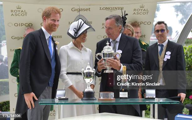 Prince Harry, Duke of Sussex and Meghan, Duchess of Sussex present the winners cup to breeder John Gunther after his horse Without Parole ridden by...