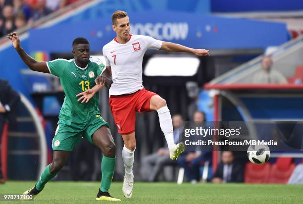 Alfred Ndiaye of Senegal competes with Arkadiusz Milik of Poland during the 2018 FIFA World Cup Russia group H match between Poland and Senegal at...