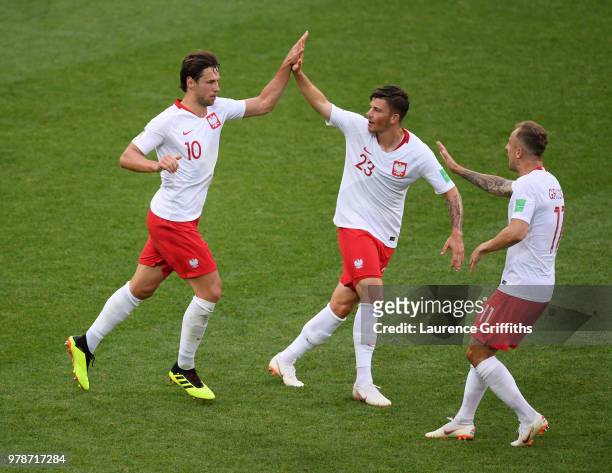 Grzegorz Krychowiak of Poland celebrates with teammates Dawid Kownacki, and Kamil Grosicki after scoring his team's first goal during the 2018 FIFA...
