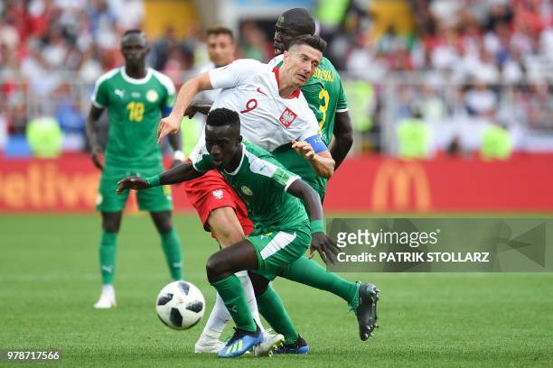 Poland's forward Robert Lewandowski vies with Senegal's defender Kalidou Koulibaly and Senegal's midfielder Idrissa Gana Gueye the Russia 2018 World...
