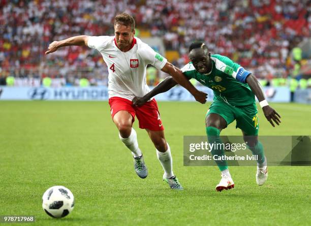 Sadio Mane of Senegal challenge for the ball with Thiago Cionek of Poland during the 2018 FIFA World Cup Russia group H match between Poland and...