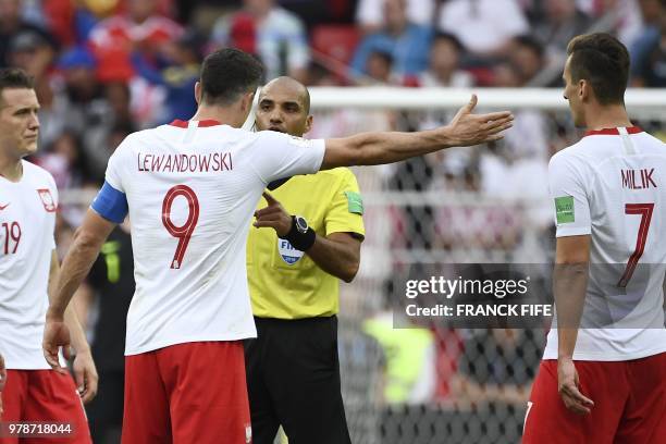 Poland's forward Robert Lewandowski argues with Bahraini referee Nawaf Abdullah Ghayyath Shukralla during the Russia 2018 World Cup Group H football...