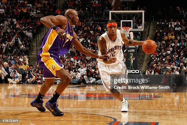 Tyrus Thomas of the Charlotte Bobcats moves the ball against Lamar Odom of the Los Angeles Lakers during the game on March 5, 2010 at the Time Warner...