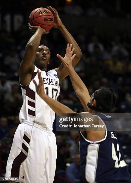 David Loubeau of the Texas A&M Aggies shoots over Tai Wesley of the Utah St. Aggies during the first round of the 2010 NCAA men's basketball...