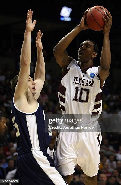 David Loubeau of the Texas A&M Aggies shoots over Nate Bendall of the Utah St. Aggies during the first round of the 2010 NCAA men's basketball...