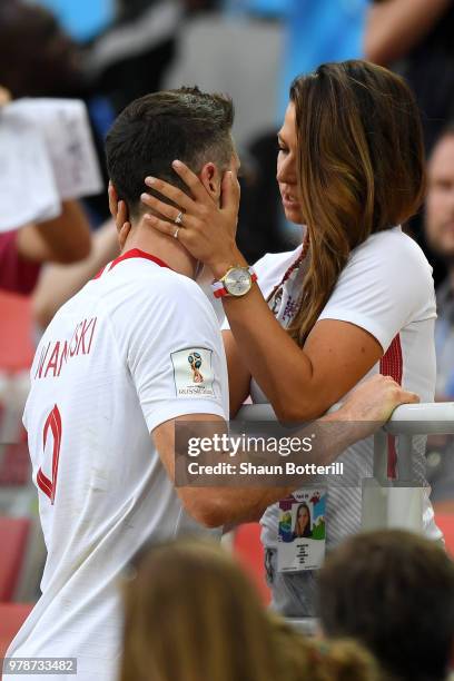 Robert Lewandowski of Poland's girlfriend, Anna Stachurska consoles Robert Lewandowski following his sides defeat in the 2018 FIFA World Cup Russia...