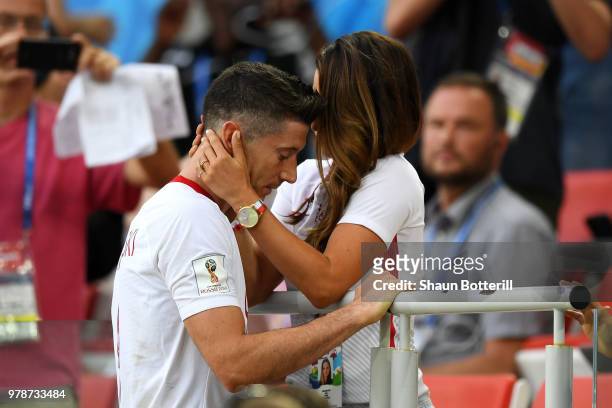 Robert Lewandowski of Poland's girlfriend, Anna Stachurska consoles Robert Lewandowski following his sides defeat in the 2018 FIFA World Cup Russia...