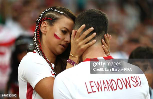 Robert Lewandowski of Poland's girlfriend, Anna Stachurska consoles Robert Lewandowski following his sides defeat in the 2018 FIFA World Cup Russia...