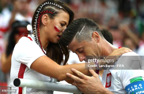 Robert Lewandowski of Poland's girlfriend, Anna Stachurska consoles Robert Lewandowski following his sides defeat in the 2018 FIFA World Cup Russia...