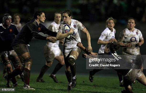 Emily Scarratt of England is challenged by Marie-Charlotte Hebel and Sandrine Agricole of France during the Women's Six Nations match between France...