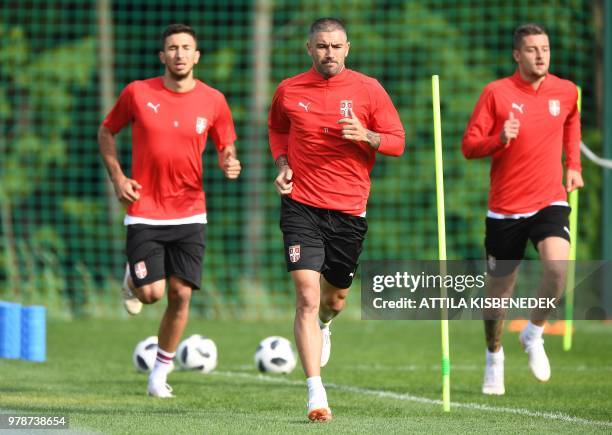 Serbia's defender Aleksandar Kolarov , Serbia's midfielder Marko Grujic and Serbia's midfielder Sergej Milinkovic-Savic take part in a training...
