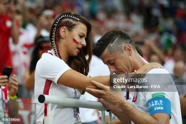 Robert Lewandowski of Poland's girlfriend, Anna Stachurska consoles Robert Lewandowski following his sides defeat in the 2018 FIFA World Cup Russia...