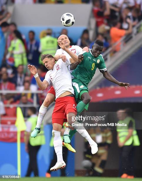 Michal Pazdan and Jan Bednarek of Poland compete with Mame Diouf of Senegal during the 2018 FIFA World Cup Russia group H match between Poland and...