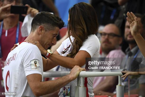 Poland's forward Robert Lewandowski is comforted by his wife Anna Lewandowska at the end the Russia 2018 World Cup Group H football match between...