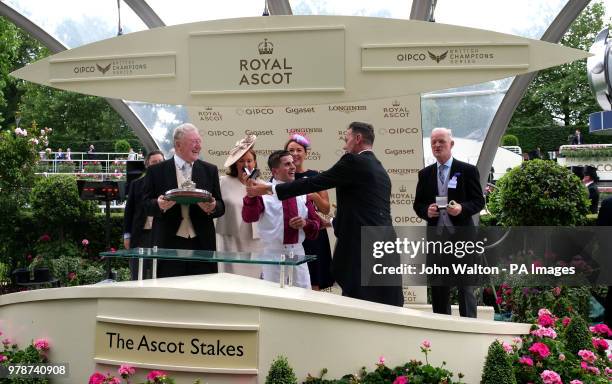 Jockey Andrea Atzeni and trainer Willie Mullins are presented with the trophies by Craig Revel Horwood after winning the Ascot Stakes with...