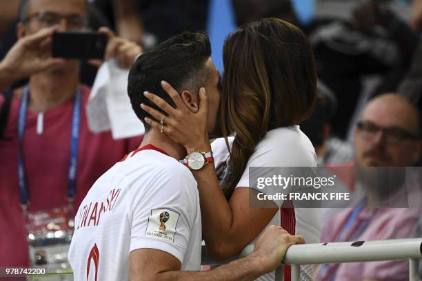 Poland's forward Robert Lewandowski kisses his wife Anna Lewandowska at the end the Russia 2018 World Cup Group H football match between Poland and...