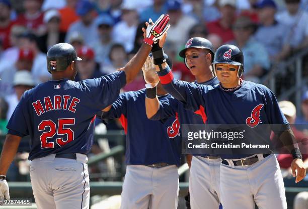 Andy Marte of the Cleveland Indians is congratulates by teammates Anderson Hernandez, Michael Brantley and Shin-Soo Choo after Marte hit a first...