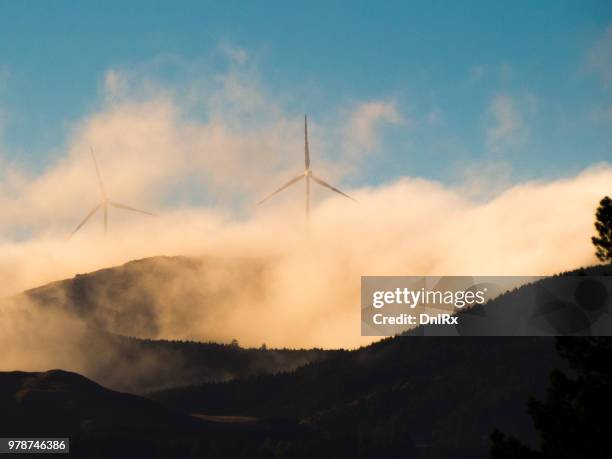 wind turbines behind clouds, palmerston north, manawatu-wanganui, new zealand - palmerston stock pictures, royalty-free photos & images