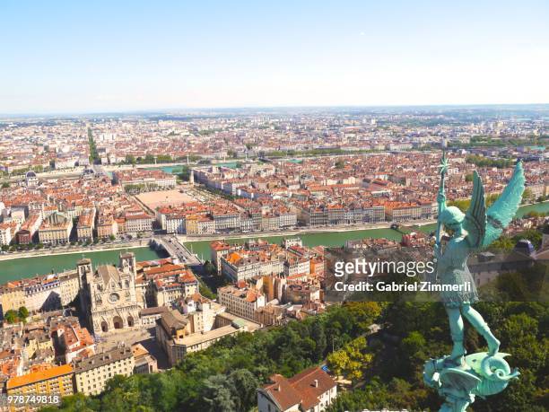 cityscape with statue of angel, lyon, france - rhone stock-fotos und bilder