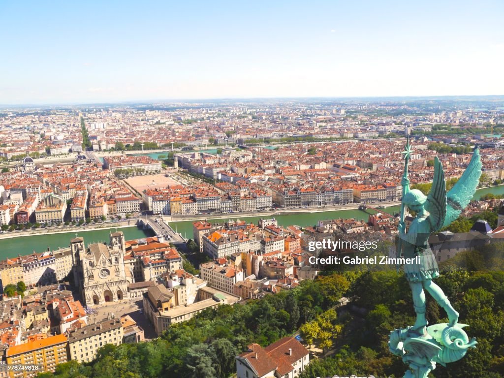 Cityscape with statue of angel, Lyon, France