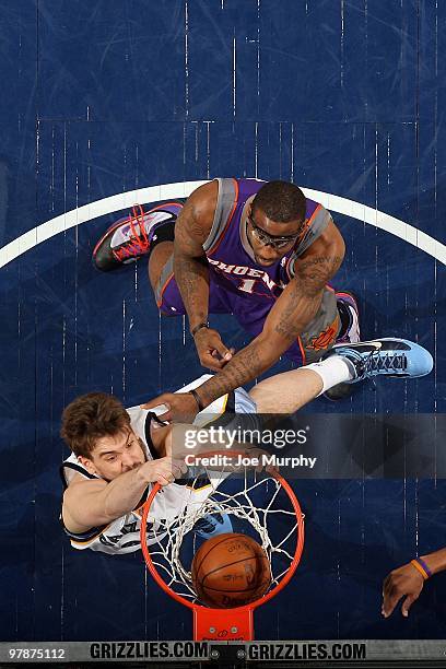 Marc Gasol of the Memphis Grizzlies dunks against Amar'e Stoudemire of the Phoenix Suns during the game on February 16, 2010 at FedExForum in...