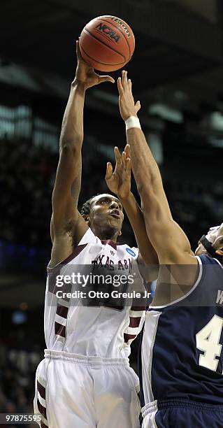 David Loubeau of the Texas A&M Aggies shoots against Tai Wesley of the Utah State Aggies during the first round of the 2010 NCAA men's basketball...