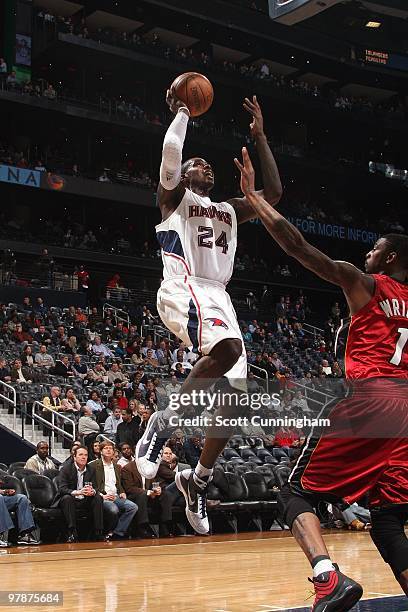 Marvin Williams of the Atlanta Hawks goes up for a shot against Dorell Wright of the Miami Heat during the game at Philips Arena on February 10, 2010...