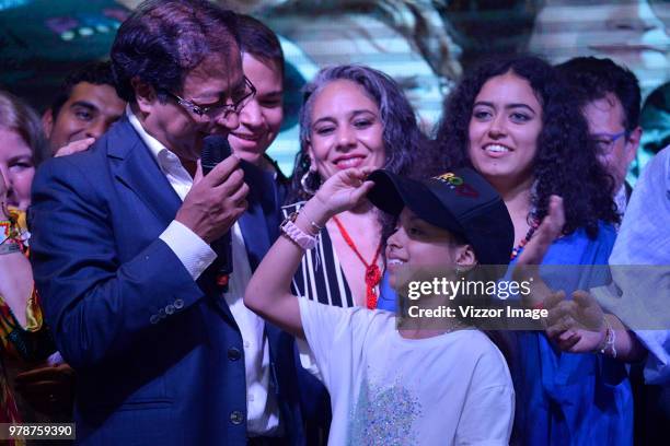 Gustavo Petro, presidential candidate for Coalicion Petro Presidente party, looks one of the daughters during his speech after losing the...