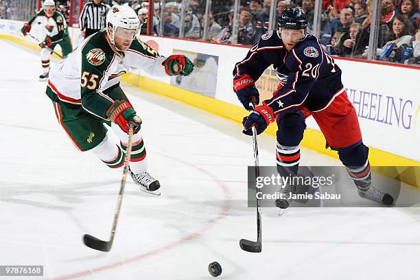 Kristian Huselius of the Columbus Blue Jackets and Nick Schultz of the Minnesota Wild chase down a loose puck during the first period on March 19,...