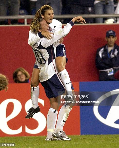 United States forward Mia Hamm celebrates with a hug from forward Abby Wambach October 1, 2003 at Gillette Stadium, Foxboro, Massachuttes, during the...