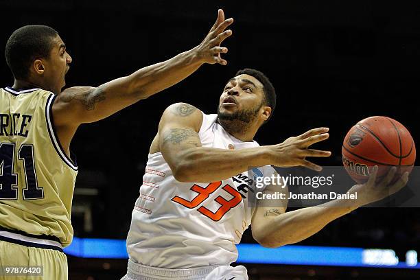 Marshall Moses of the Oklahoma State Cowboys goes up for a shot against Glen Rice Jr. #41 of the Georgia Tech Yellow Jackets in the first half during...