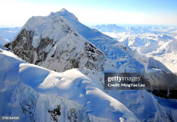 aerial view of snow-capped mountain peak on sunny day, alaska, usa - cathedral peaks stockfoto's en -beelden